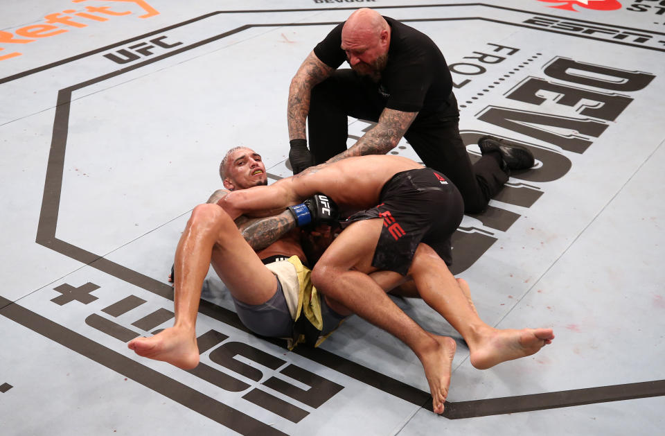 BRASILIA, BRAZIL - MARCH 14: (L-R) Charles Oliveira of Brazil secures a guillotine choke submission against Kevin Lee in their lightweight fight during the UFC Fight Night event on March 14, 2020 in Brasilia, Brazil. (Photo by Buda Mendes/Zuffa LLC)