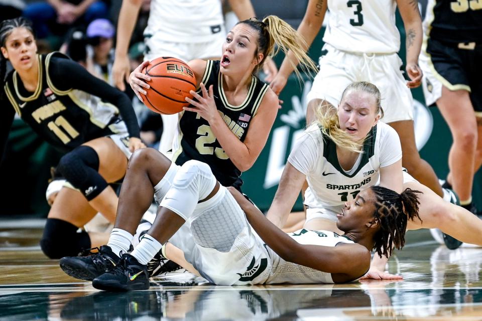 Michigan State's Kamaria McDaniel, bottom, and Matilda Ekh, right, battle Purdue's Abbey Ellis for the ball during the first quarter on Monday, Dec. 5, 2022, at the Breslin Center in East Lansing.