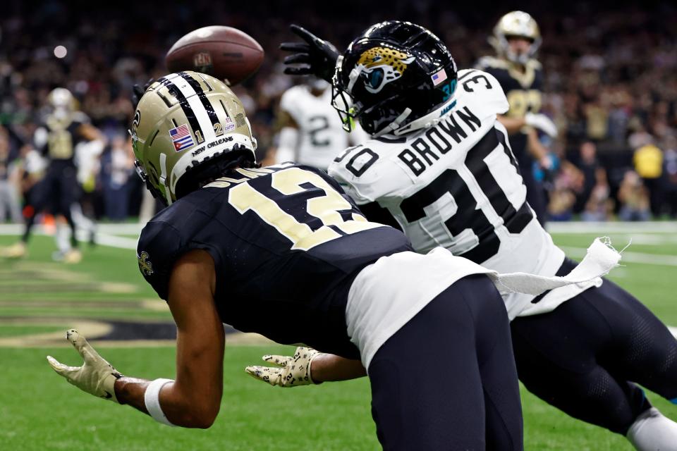 Jacksonville Jaguars cornerback Montaric Brown (30) breaks up a pass intended for New Orleans Saints wide receiver Chris Olave (12) on a fourth down play in the second half of an NFL football game in New Orleans, Thursday, Oct. 19, 2023. (AP Photo/Butch Dill)