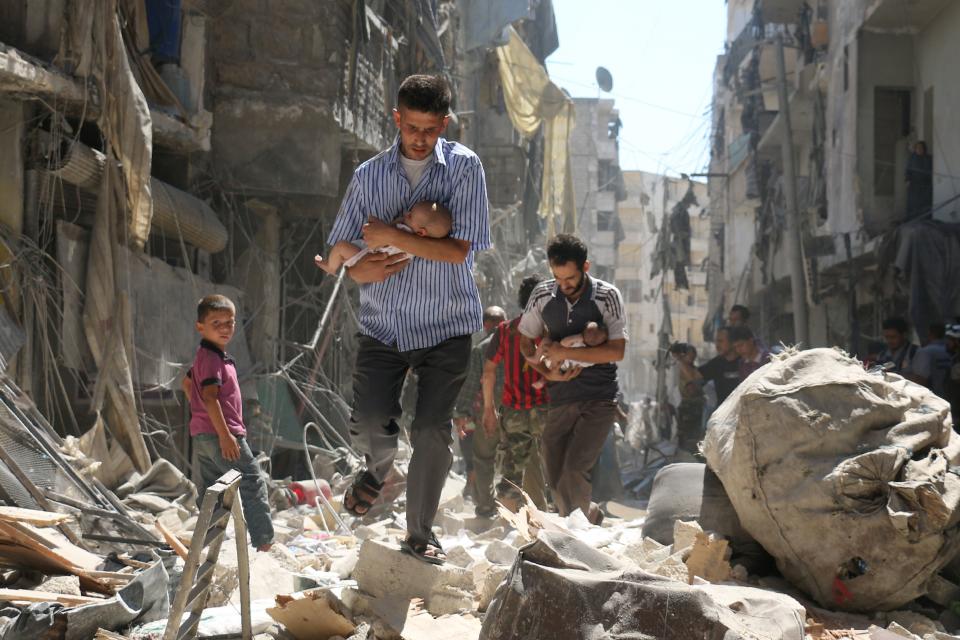 Survivors of a reported air strike a section of Aleppo