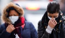 People wearing masks leave Creil's hospital, where people tested positive for coronavirus have been treated