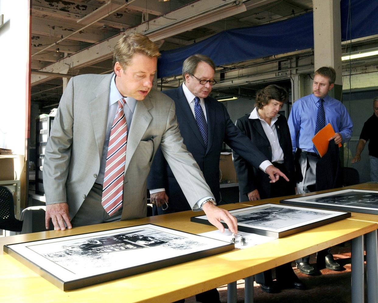 Ford Motor Co. Executive Chairman Bill Ford, the great-grandson of company founder Henry Ford, reviews family memorabilia  for the centennial celebration of the Model T at the historic Piquette Plant. He is joined by his cousin, Edsel B. Ford II, his  cousin Elena Ford, who at the time lead the global marketing efforts for Ford Credit, and Henry Ford III, the great-great-grandson of Henry Ford who at the time was a purchasing analyst for North American Vehicle Programs at Ford.