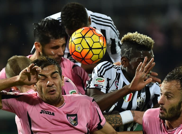 Juventus' defender from France Patrice Evra (Top) and Juventus' midfielder from France Paul Pogba (2ndR) vie with Palermo's defenders during the Italian Serie A football match on November 29, 2015 at the Renzo Barbera stadium in Palermo