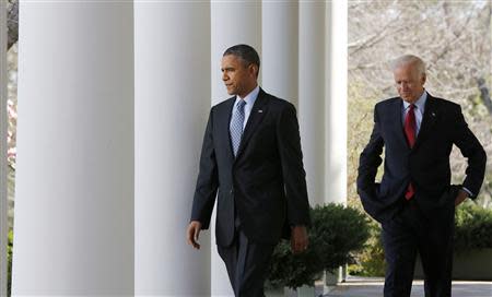 U.S. President Barack Obama (L) walks out next to Vice President Joseph Biden before he talks about the enrolment numbers of the Affordable Care Act at the White House in Washington, April 1, 2014. REUTERS/Larry Downing