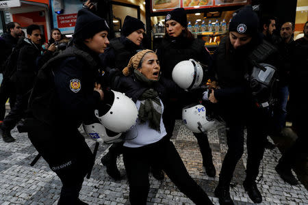 Riot police detain a demonstrator during a protest against Turkey's military operation in Syria's Afrin region, in Istanbul, Turkey January 21, 2018. REUTERS/Umit Bektas