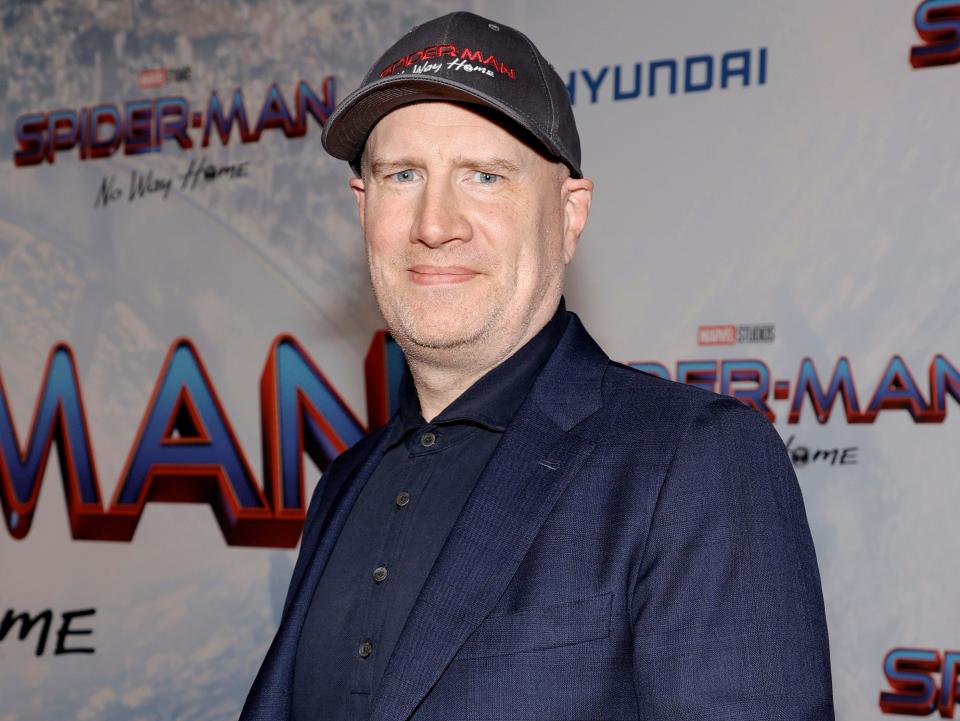 Kevin Feige in a blue suit and baseball cap