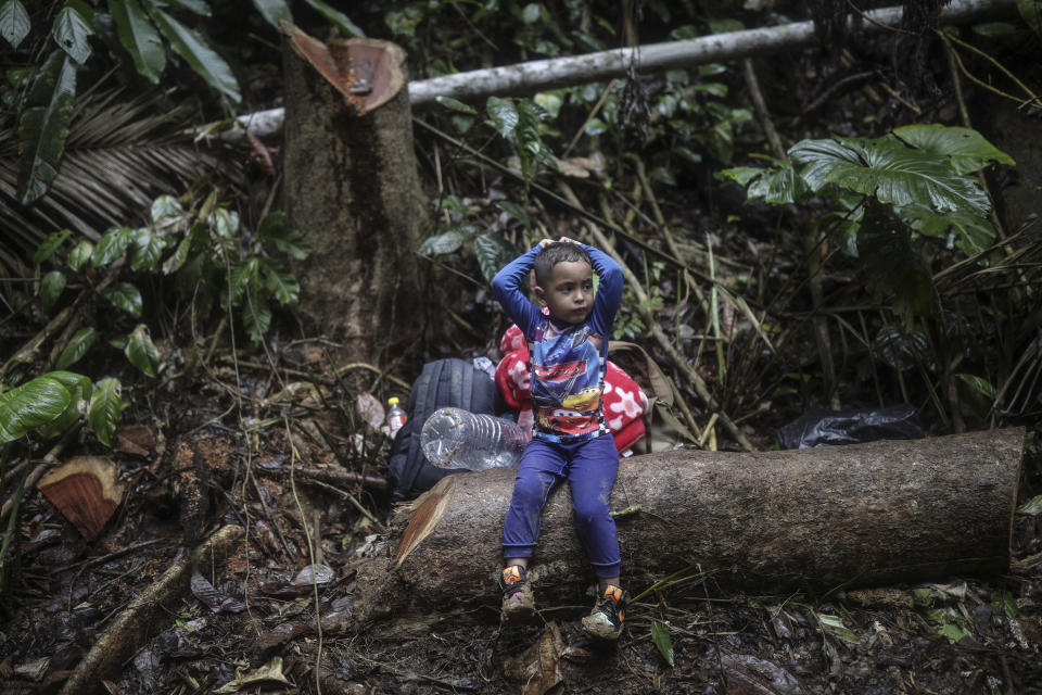 A Venezuelan boy crossing the Darien Gap with his family from Colombia to Panama, in hopes of reaching the U.S., rests Tuesday, May 9, 2023. Pandemic-related U.S. asylum restrictions, known as Title 42, are to expire Thursday, May 11. (AP Photo/Ivan Valencia)