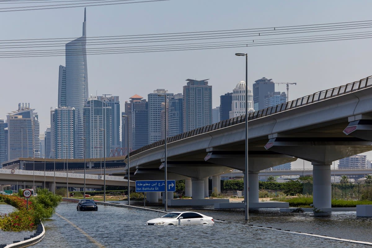 Abandoned vehicles in floodwater along Sheikh Zayed Road highway in Dubai (AP)