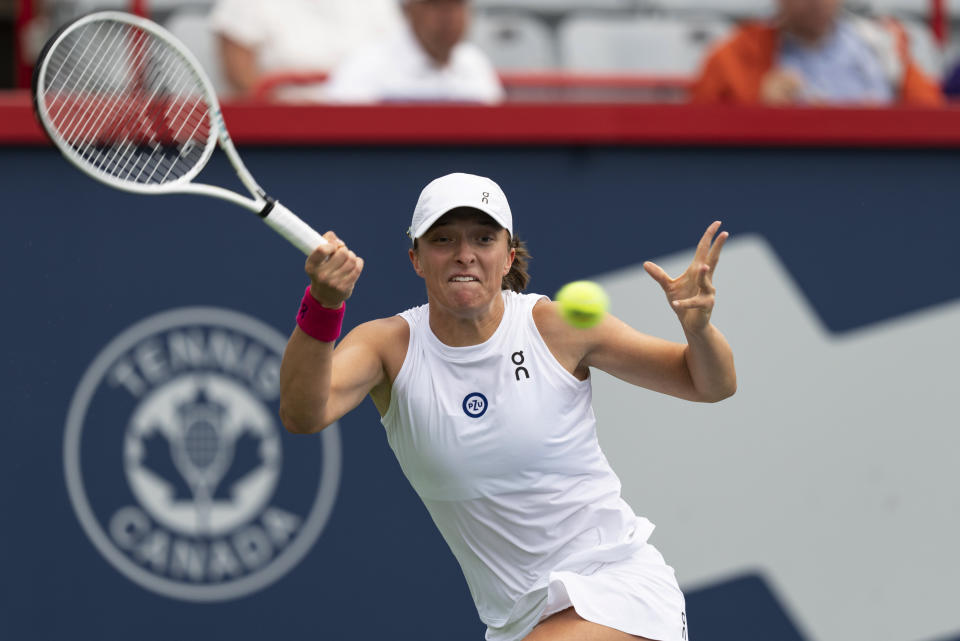 Iga Swiatek, of Poland, hits a forehand to Danielle Collins, of the United States, during the National Bank Open women’s tennis tournament Friday, Aug. 11, 2023, in Montreal. (Christinne Muschi/The Canadian Press via AP)