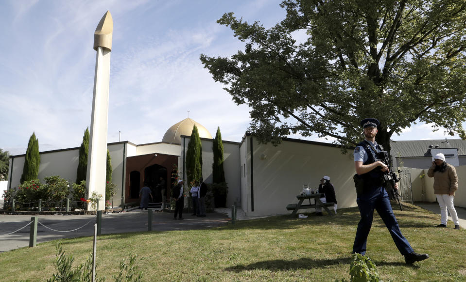 FILE - An armed policeman patrols the grounds at the Al Noor mosque following the previous week's mass shooting in Christchurch, New Zealand, on March 23, 2019. New Zealand’s government will overhaul the tighter gun laws introduced after a deadly mass shooting by a white supremacist five years ago, because they put excessive burdens on gun owners who feel vilified by law enforcement and the public, the lawmaker leading the changes said. (AP Photo/Mark Baker, File)
