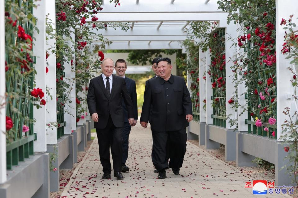 Russia’s president Vladimir Putin and North Korea’s leader Kim Jong-un react during a walk in the garden of the Kumsusan Guesthouse in Pyongyang (via REUTERS)