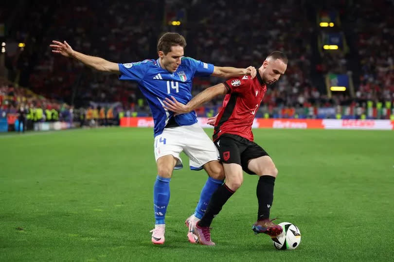 Mario Mitaj of Albania is challenged by Federico Chiesa of Italy during the UEFA EURO 2024 group stage match between Italy and Albania at Football Stadium Dortmund on June 15, 2024 in Dortmund, Germany.