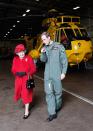 <p>Prince William shows Queen Elizabeth II the hanger where the helicopter he flies is kept in Anglesey. (PA) </p>