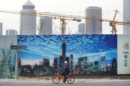 A man cycles outside the construction sites in Beijing's central business area, China January 18, 2019. REUTERS/Jason Lee