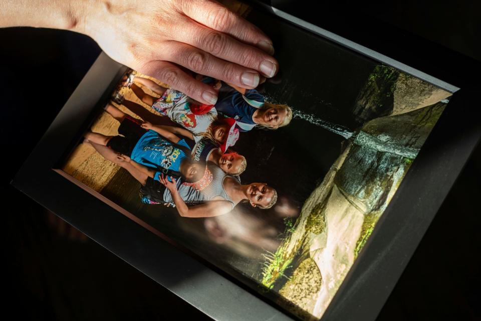 Sarah Markiewicz, 44, of Rochester Hills holds a photo of herself with her children at her home in Rochester Hills on Wednesday, November 9, 2022. Markiewicz is fighting over custody of a frozen embryo with her ex-husband, that is the product of the husband's sperm and her sister's egg.