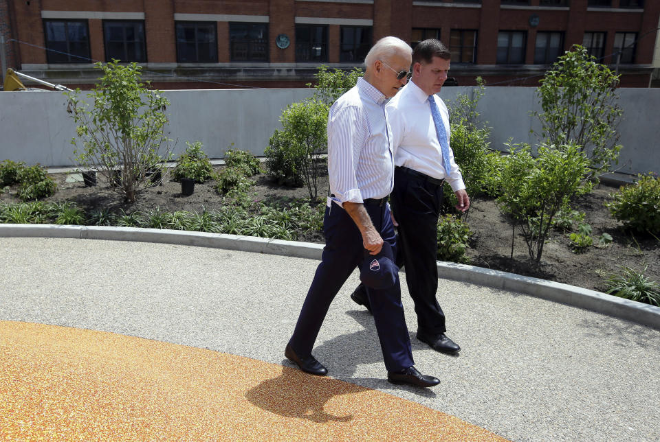 Former vice president and Democratic presidential candidate Joe Biden walks on Wednesday, June 5, 2019, beside Boston Mayor Marty Walsh, right, in a park in being constructed in Boston in honor of Martin Richard, the youngest victim of the 2013 Boston Marathon bombings. (AP Photo/Steven Senne)