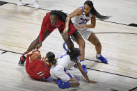 Louisville's Norika Konno, bottom left, and Olivia Cochran, top left, keep the ball from DePaul's Maya Stovall, bottom right, and Kayla Caudle, top right, during the first half of an NCAA college basketball game Friday, Dec. 4, 2020, in Uncasville, Conn. (AP Photo/Jessica Hill)