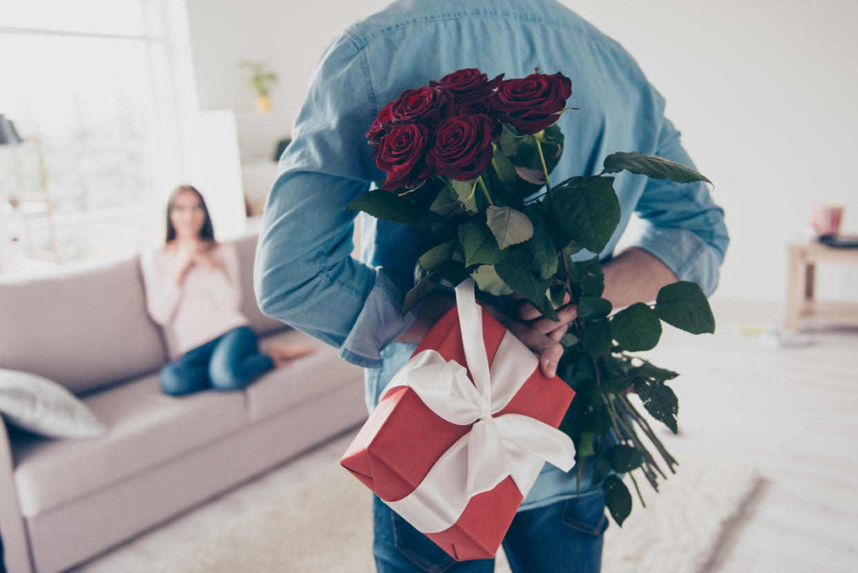 Image of man showering his partner with presents, which could be a sign of Intimate Partner Violence. (Getty Images)