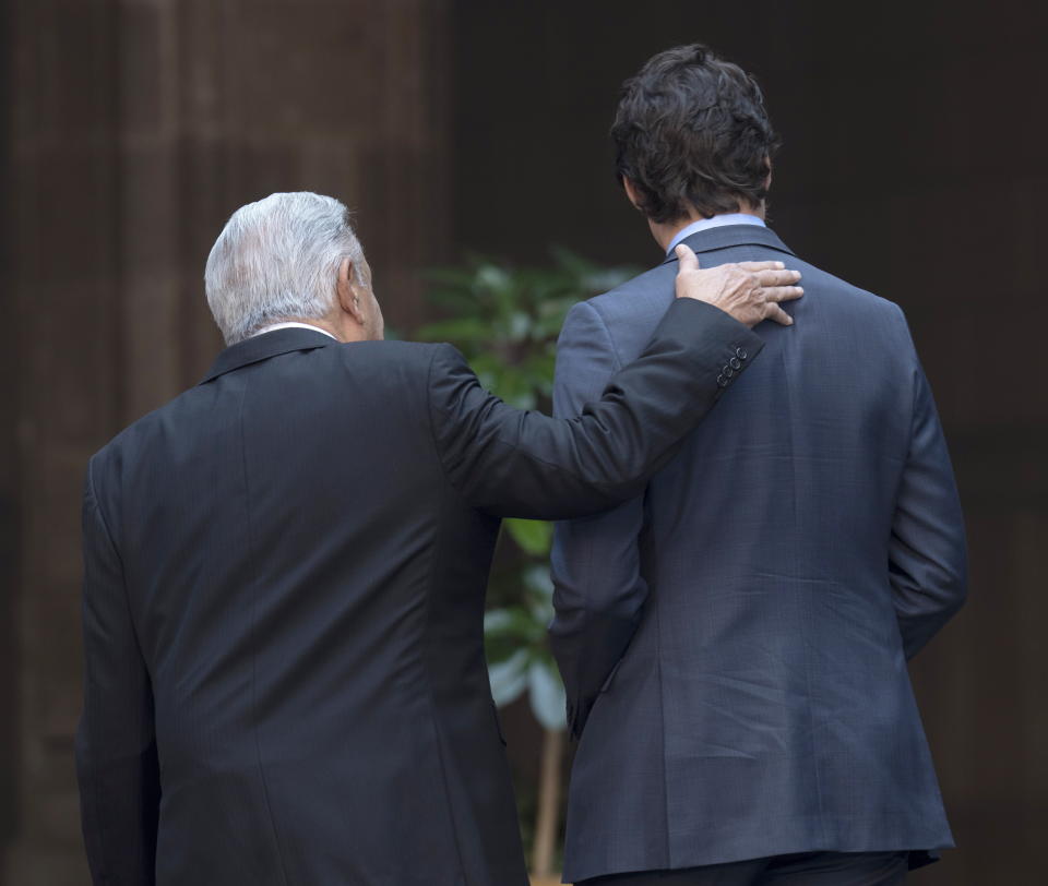 Mexican President Andres Manuel Lopez Obrador places his hand on the back of Prime Minister Justin Trudeau as he arrives at the National Palace in Mexico City, Mexico, Wednesday Jan.11, 2023. (Adrian Wyld /The Canadian Press via AP)