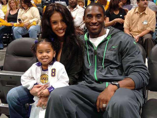 <p>Andrew D. Bernstein/NBAE/Getty</p> Kobe Bryant, Vanessa Bryant, and child Natalia watch the Los Angeles Sparks play the Sacramento Monarchs on August 16, 2005 at Staples Center in Los Angeles, California.