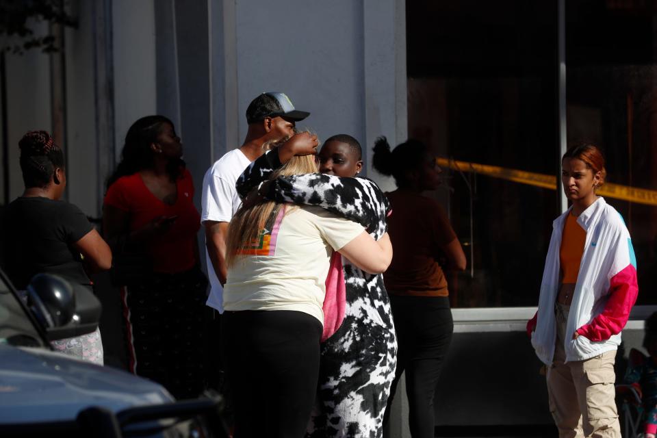 Family and friends console each other while the Tampa Police Department and the Hillsborough County Sheriff's Office investigates a fatal shooting in the Ybor City neighborhood on Oct. 29, 2023 in Tampa, Florida. According to reports, two people from two different groups opened fire as hundreds of people were on the street early Sunday morning in an area filled with bars and clubs.