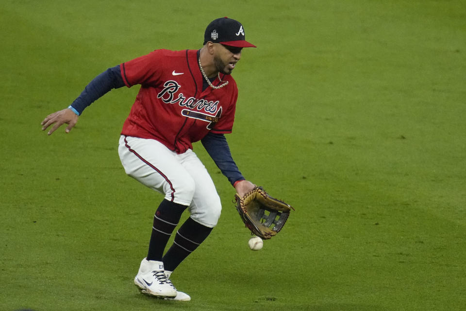 Atlanta Braves left fielder Eddie Rosario can't get a glove on a fly ball hit by Houston Astros' Aledmys Diaz during the eighth inning in Game 3 of baseball's World Series between the Houston Astros and the Atlanta Braves Friday, Oct. 29, 2021, in Atlanta. (AP Photo/Ashley Landis)