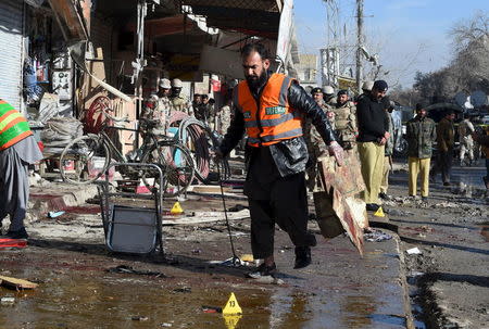 A rescue worker collects evidence from the site of a suicide bomb attack close to a polio eradication centre in Quetta, Pakistan, January 13, 2016. REUTERS/Stringer