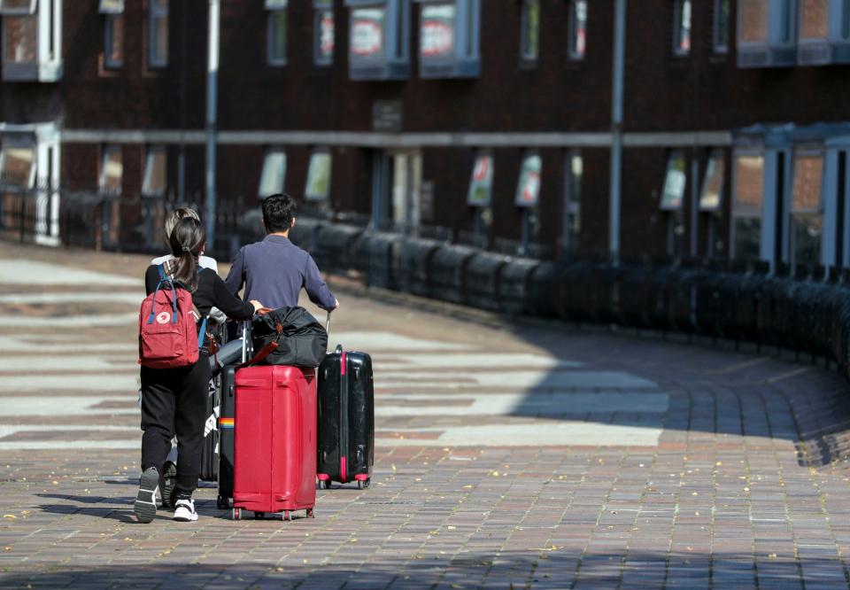 Students arrive at a accommodation block for the University of Portsmouth as students prepare to return or begin their studies: PA