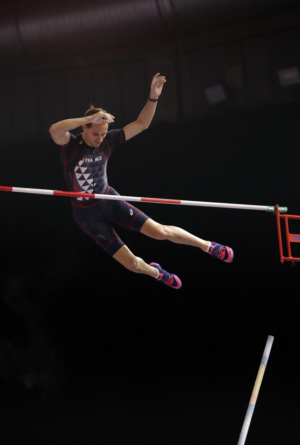 FILE - In this March 4, 2018, file photo, France's Renaud Lavillenie clears the bar in the men's pole vault final at the World Athletics Indoor Championships in Birmingham, Britain. The three biggest names in men’s pole vault will compete against each other from their own backyards, Sunday, May 3, 2020, in a rare sporting event during the coronavirus pandemic. Video links will connect world record holder Mondo Duplantis, world champion Sam Kendricks and former Olympic champion Renaud Lavillenie. World Athletics calls it “The Ultimate Garden Clash” and will stream it on social media.(AP Photo/Matt Dunham, File)