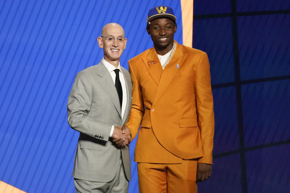 Jonathan Kuminga, right, poses for a photo with NBA Commissioner Adam Silver after being selected seventh overall by the Golden State Warriors during the NBA basketball draft, Thursday, July 29, 2021, in New York. (AP Photo/Corey Sipkin)