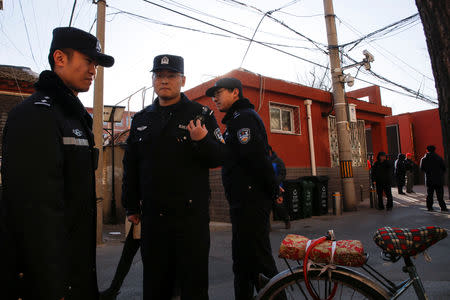Police stand outside a primary school that was the scene of a knife attack in Beijing, China, January 8, 2019. REUTERS/Thomas Peter