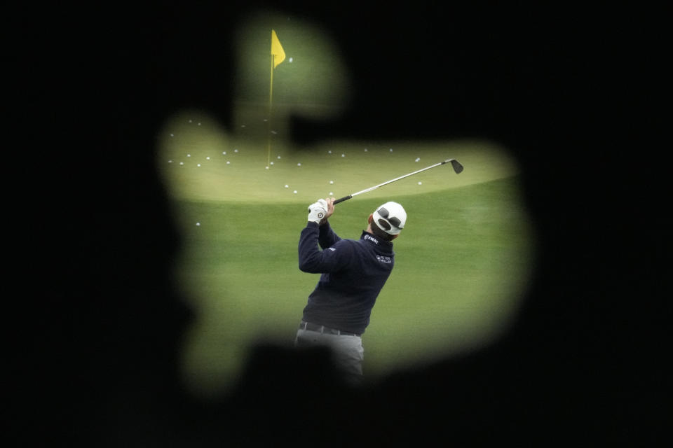 Kevin Kisner works out on the range during a practice for the Masters golf tournament at Augusta National Golf Club, Monday, April 3, 2023, in Augusta, Ga. (AP Photo/Charlie Riedel)