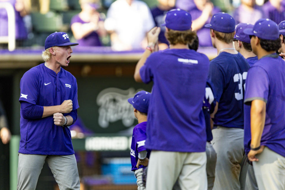 TCU starting pitcher Kole Klecker, left, celebrates the team's win over Indiana State in an NCAA college baseball tournament super regional game in Fort Worth, Texas, Friday, June 9, 2023. (AP Photo/Brandon Wade)