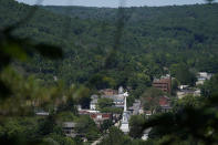 Surrounded by trees and mountains, Ellenville, N.Y., is seen Wednesday, June 16, 2021. Less than 100 miles north of New York City, Ulster County is popular destination for weekenders headed to Woodstock or the Catskill Mountains. Though pretty, there are pockets of poverty. The county is working with the Center for Guaranteed Income Research at the University of Pennsylvania on a pilot program funded by private donations. One hundred households making less than $46,900 a year in May began receiving a $500 payment each month for a year. Recipients of the money can spend it as they wish, but will be asked to participate in periodic surveys about their physical health, mental health and employment status. (AP Photo/Seth Wenig)