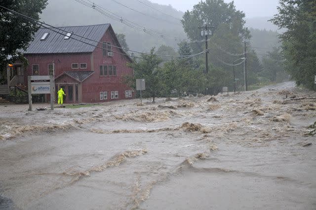 <p>Universal Images Group via Getty</p> Flood waters in Waitsfield, Vermont