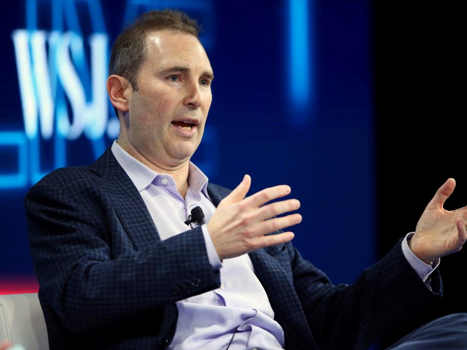 Amazon CEO Andy Jassy motions with his hands onstage at a conference.