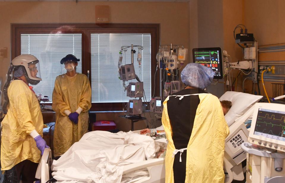 Inside the ICU at Parrish Medical Center Dr. Aluino Ochoa, ICU nurse practitioner Jennifer Watts and Helen Campbell, RN, tend to a COVID-19 patient. 