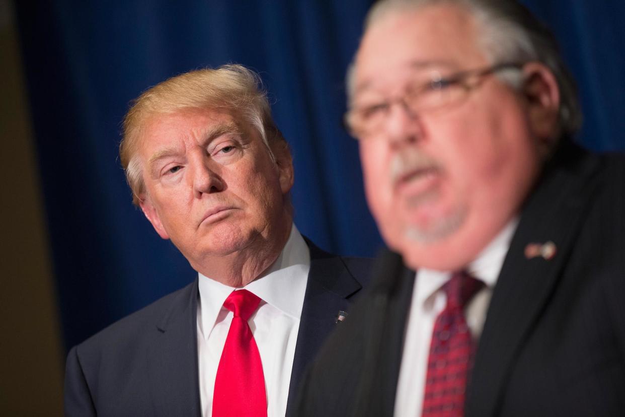 Republican presidential candidate Donald Trump listens as Sam Clovis speaks at a press conference: Getty Images