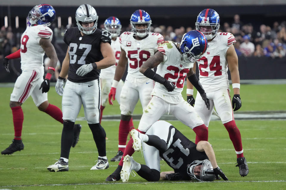 New York Giants cornerback Cor'Dale Flott (28) hits Las Vegas Raiders wide receiver Hunter Renfrow (13) during the second half of an NFL football game, Sunday, Nov. 5, 2023, in Las Vegas. (AP Photo/Rick Scuteri)