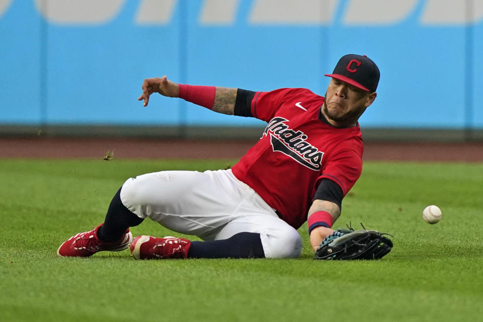 Cleveland Indians' Harold Ramirez dives for a double hit by Detroit Tigers' Nomar Mazara during the fifth inning in the first baseball game of a doubleheader, Wednesday, June 30, 2021, in Cleveland. (AP Photo/Tony Dejak)