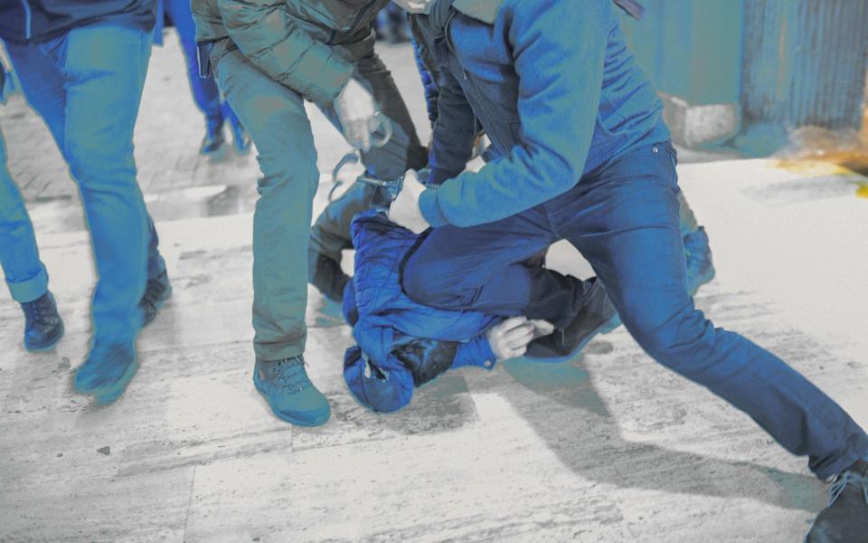 Turkish police officers detain a protester  - BULENT KILIC/AFP via Getty Images