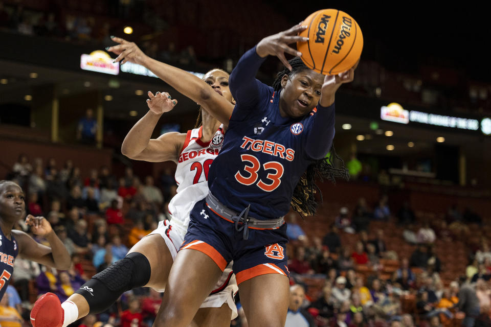 Auburn's Kharyssa Richardson (33) grabs a rebound next to Georgia's Jordan Isaacs (20) during the first half of an NCAA college basketball game in the Southeastern Conference women's tournament in Greenville, S.C., Thursday, March 2, 2023. (AP Photo/Mic Smith)