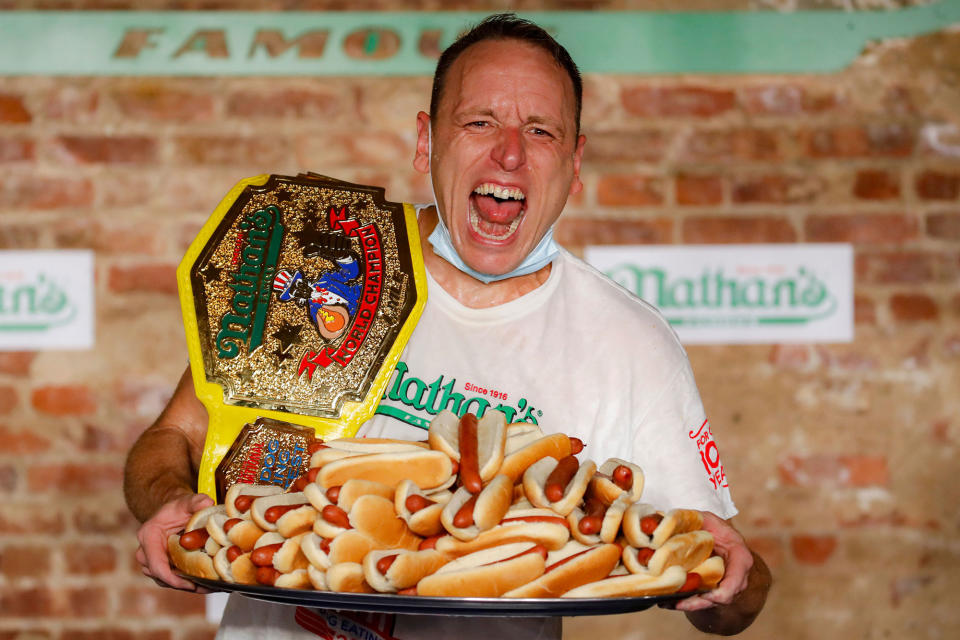 <p>In 2020, Joey Chestnut broke his own record <em>again</em> <a href="https://people.com/food/joey-chestnut-nathans-hot-dog-eating-competition-2019-winner/" rel="nofollow noopener" target="_blank" data-ylk="slk:when he put away 75 hot dogs in 10 minutes (a total of 21.750 calories.;elm:context_link;itc:0;sec:content-canvas" class="link ">when he put away 75 hot dogs in 10 minutes (a total of 21.750 calories.</a> Can he top himself this year? </p>