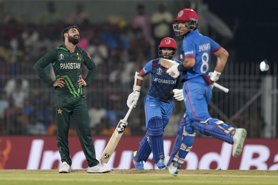 Pakistan's Shadab Khan reacts Afghanistan's captain Hashimatullah Shahidi, right, and Rahmat Shah takes a run during the ICC Men's Cricket World Cup match between Pakistan and Afghanistan in Chennai, India, Monday, Oct. 23, 2023. (AP Photo/Eranga Jayawardena)