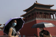 Women wearing face masks to protect against the spread of the new coronavirus look as they visit to Forbidden City in Beijing, Thursday, May 28, 2020. South Korea on Thursday reported its biggest jump in coronavirus cases in more than 50 days, a resurgence that health officials warn is getting harder to track and risks erasing some of the nation's hard-won gains. (AP Photo/Andy Wong)