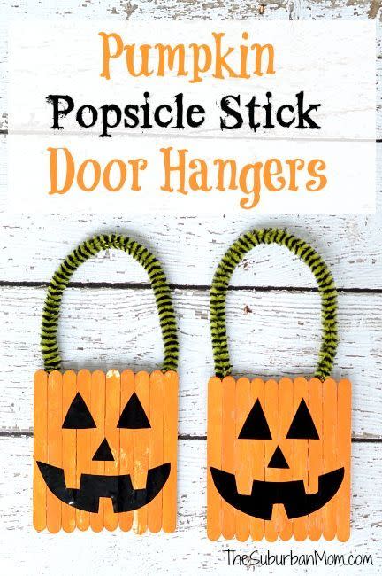 <p>Amp up the exterior of your home with these kid-friendly door hangers that are crafted with painted popsicle sticks and pipe cleaners. </p><p><em><a href="https://www.thesuburbanmom.com/2013/09/25/how-to-make-a-halloween-pumpkin-popsicle-stick-door-hanger-craft/" rel="nofollow noopener" target="_blank" data-ylk="slk:Get the tutorial at The Suburban Mom »;elm:context_link;itc:0;sec:content-canvas" class="link ">Get the tutorial at The Suburban Mom »</a></em></p>