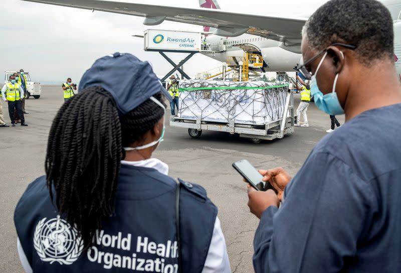 FILE PHOTO: WHO officials attend the arrival of the first batch of vaccines against the COVID-19, in Kigali