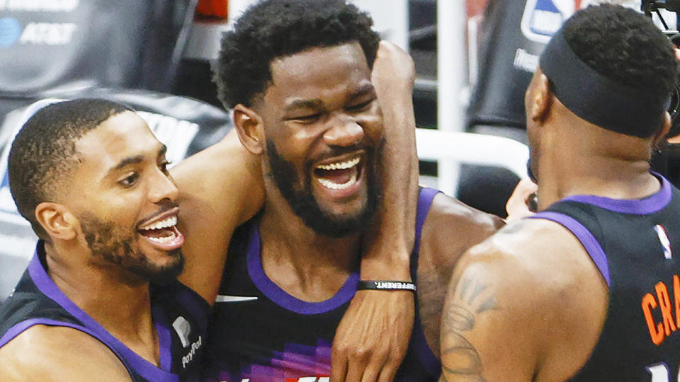 DeAndre Ayton celebrates with Phoenix Suns teammates after winning game two of the Western Conference Finals.