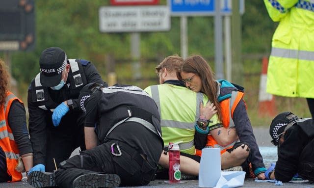 Police officers work to free protesters