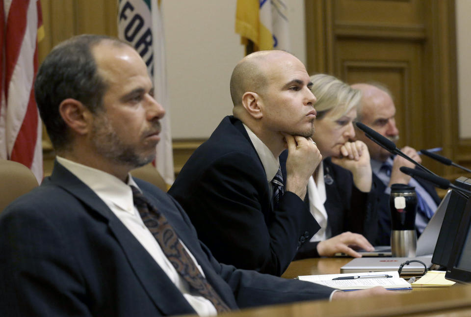 San Francisco Municipal Transportation Authority board of directors Edward D. Reiskin, director of transportation, from left, Joel Ramos, Cheryl Brinkman, vice chairman, and Tom Nolan, chairman, listen to speakers at a SFMTA meeting at City Hall in San Francisco, Tuesday, Jan. 21, 2014. San Francisco officials voted in favor of a proposal to start regulating employee shuttles for companies like Google, Facebook and Apple, charging a fee for those that use public bus stops and controlling where they load and unload. Private shuttle buses have created traffic problems, blocking public bus stops during peak commute hours. (AP Photo/Jeff Chiu)